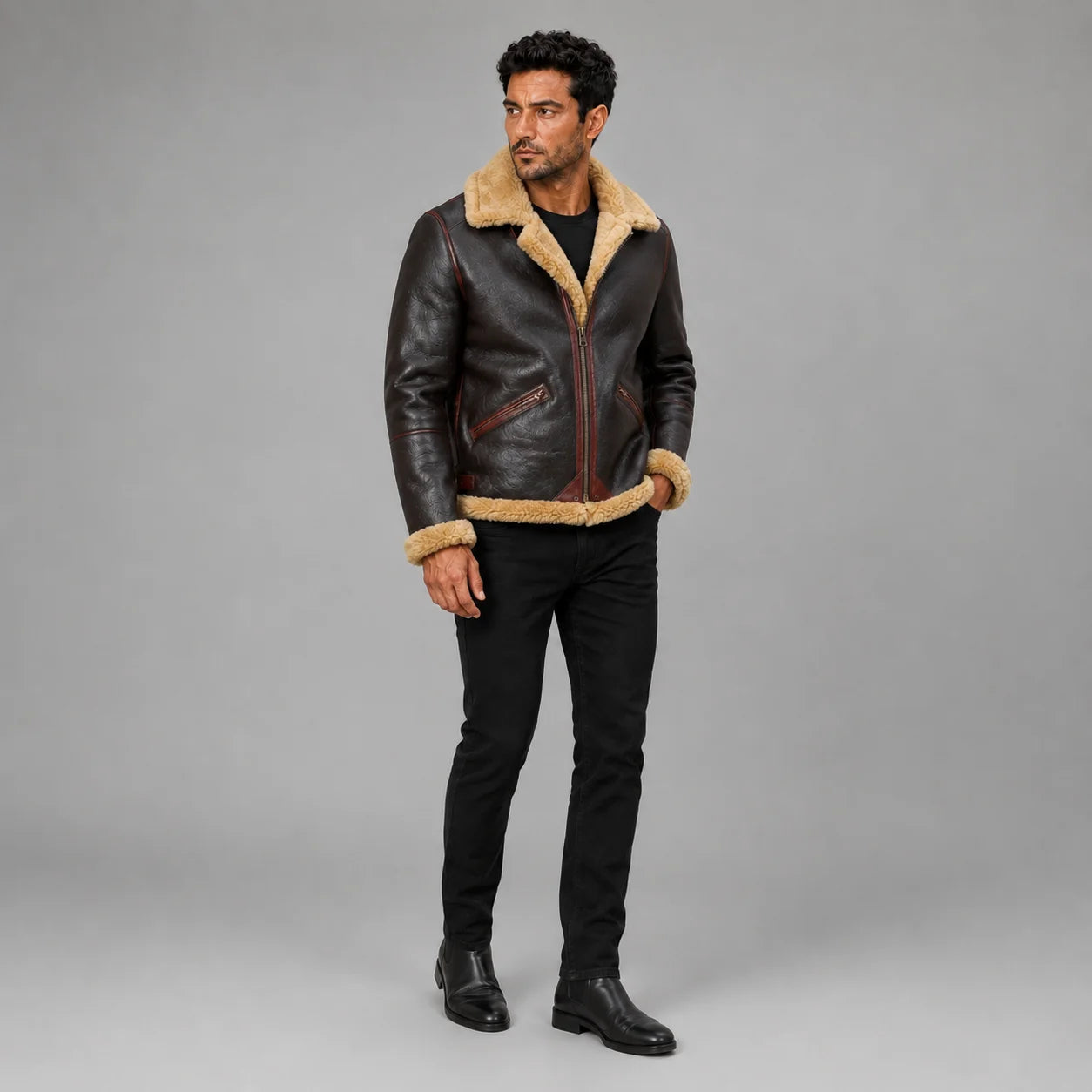 Three-quarter view of men’s brown aviator jacket with tan plush trim, burgundy piping and zipped pockets