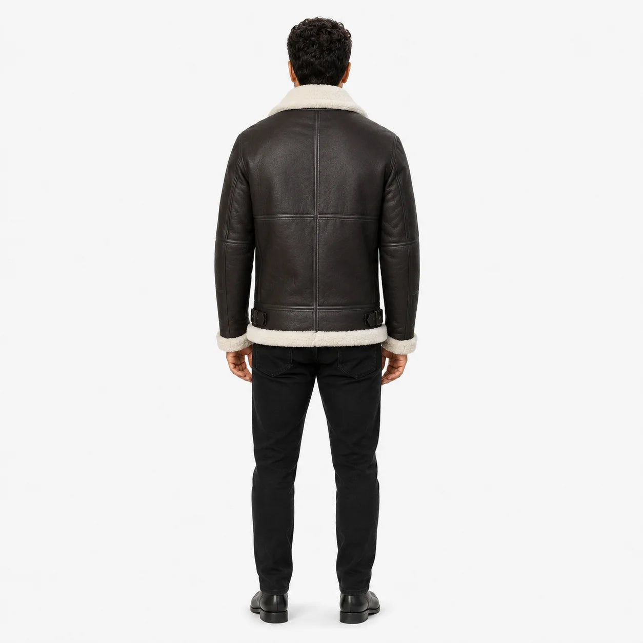 Rear model view of brown leather flight jacket showing cream collar, panelled back and side waist adjusters.