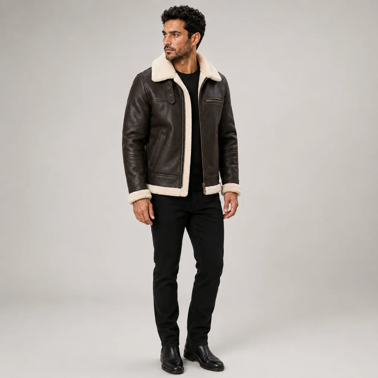Three-quarter view of men’s brown aviator leather jacket with cream shearling trim, chest zip and side pockets.