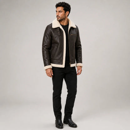 Three-quarter view of men’s brown aviator leather jacket with cream shearling trim, chest zip and side pockets.
