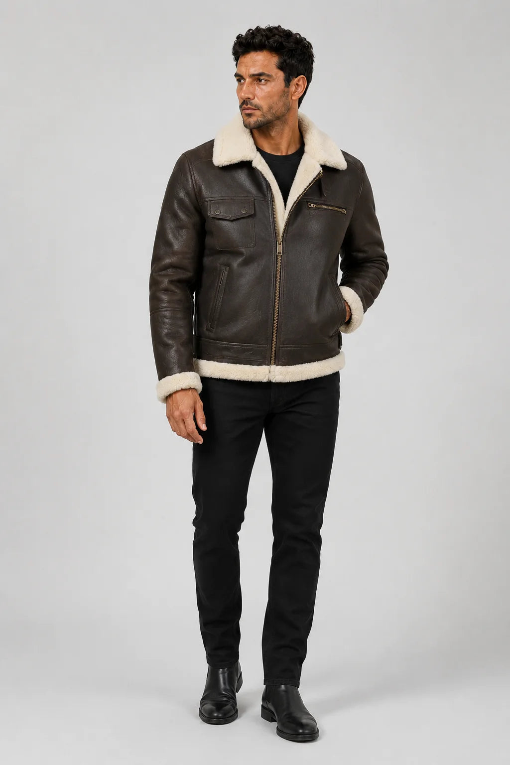Front studio model view of dark brown shearling-lined bomber jacket with chest pockets and straight zip closure.