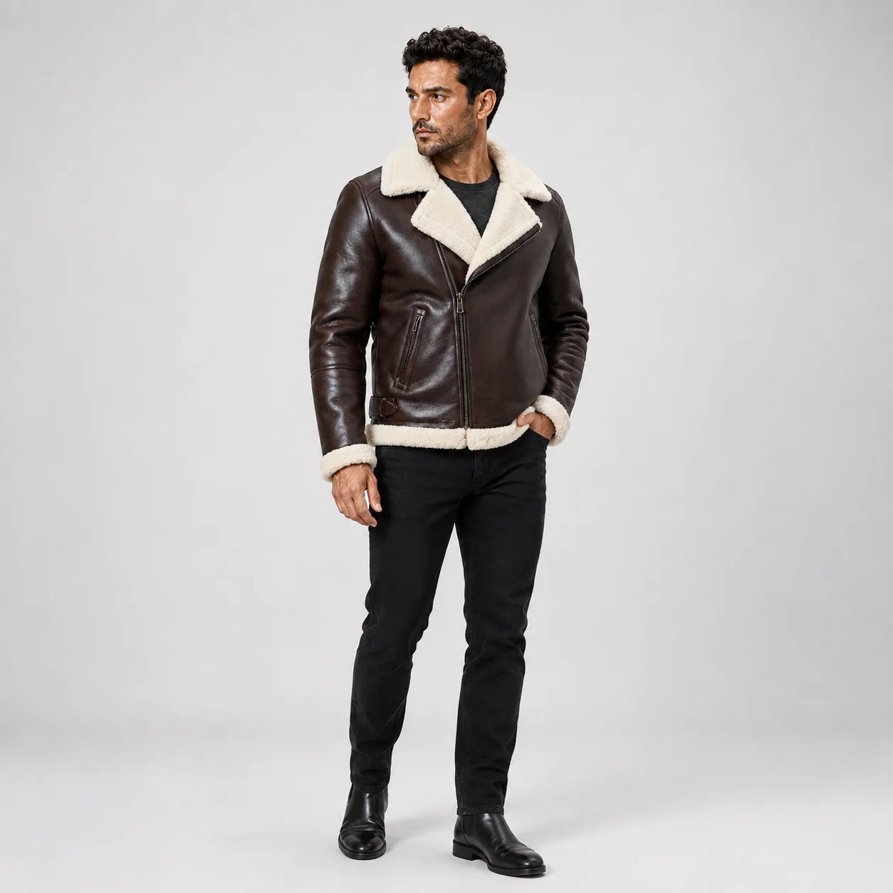 Full-length front model view wearing a dark brown B3 aviator jacket with cream shearling trim, zip front and black jeans.