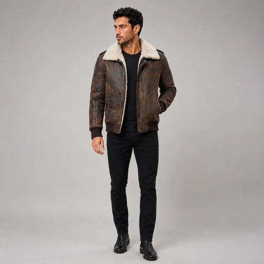 Full-length studio view of men’s distressed dark brown aviator jacket with cream shearling collar and ribbed hem