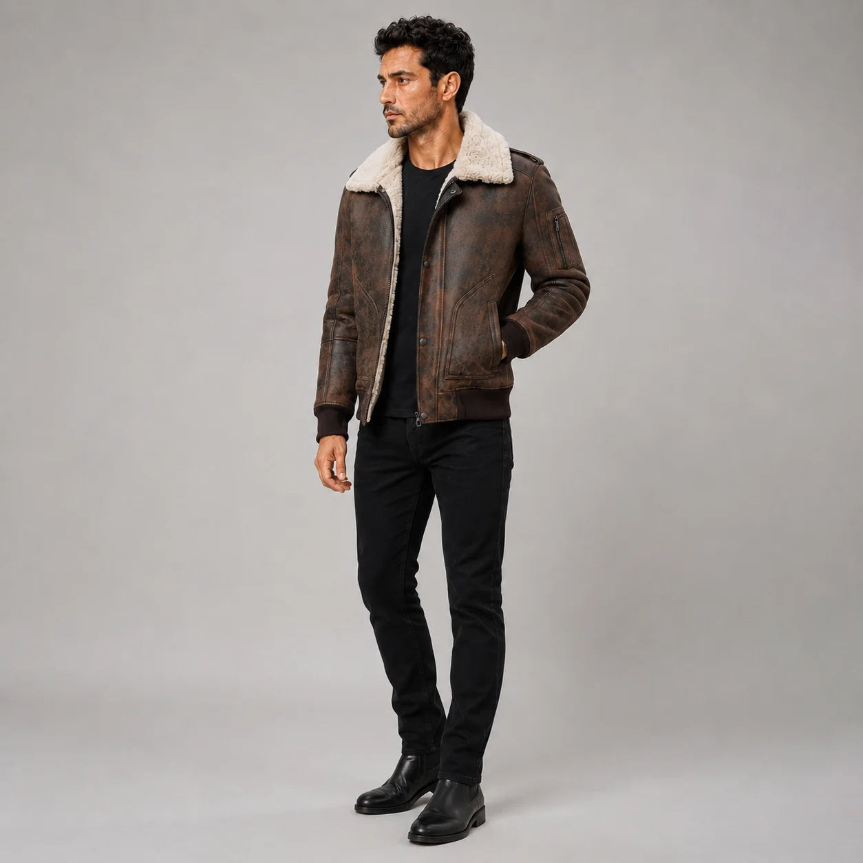 Three-quarter studio view of brown RAF shearling jacket showing front pockets, sleeve zip pocket and distressed finish