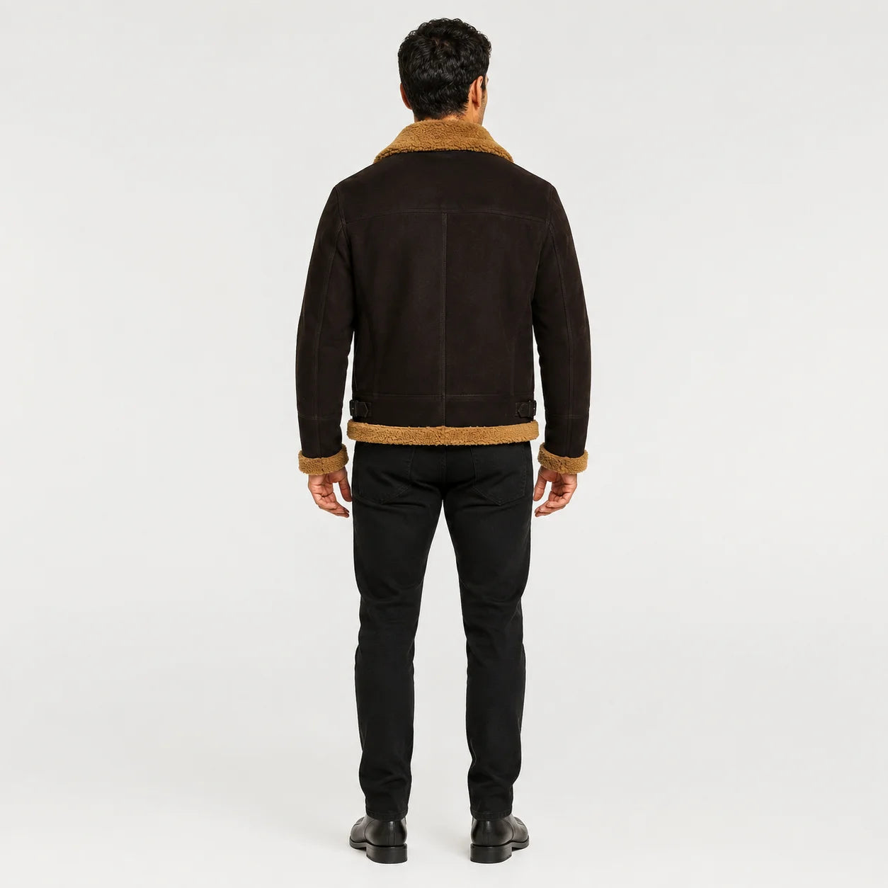 Rear model view showing brown sheepskin aviator jacket with tan collar, back yoke, centre seam and side waist adjusters