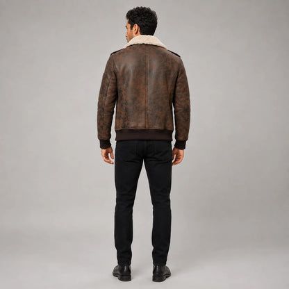 Rear studio view of men’s dark brown flight jacket showing clean back panels, cream collar and rib-knit waistband
