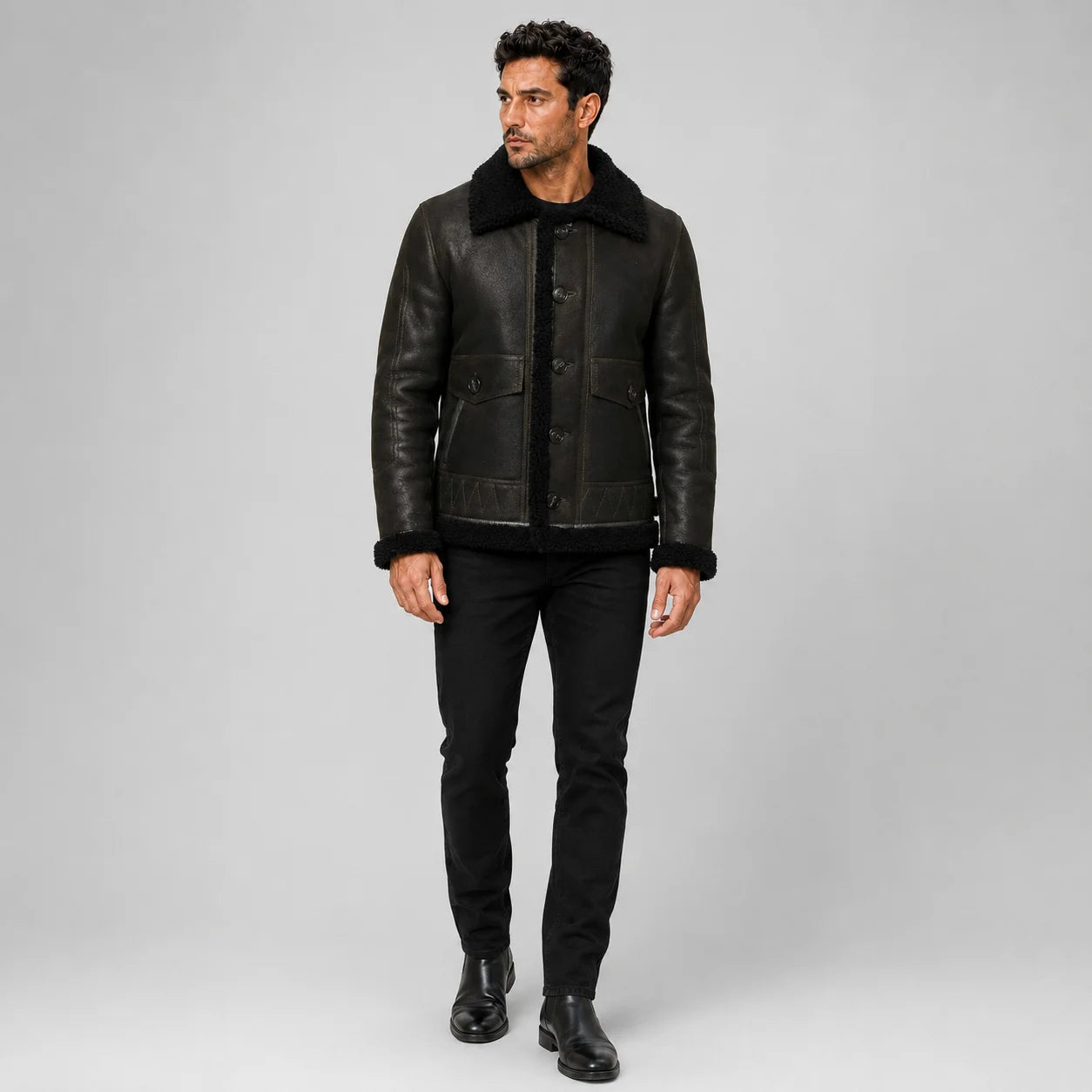 Front model view of men’s dark green aviator jacket with black plush collar, button closure and flap pockets