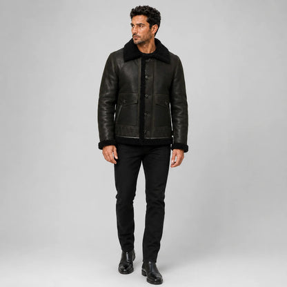 Front model view of men’s dark green aviator jacket with black plush collar, button closure and flap pockets