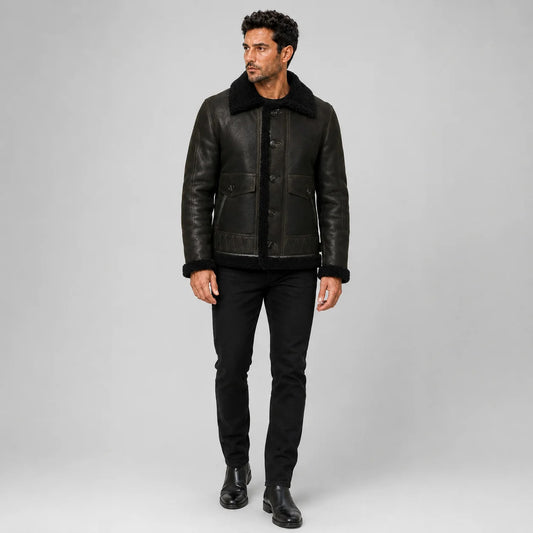 Front model view of men’s dark green aviator jacket with black plush collar, button closure and flap pockets