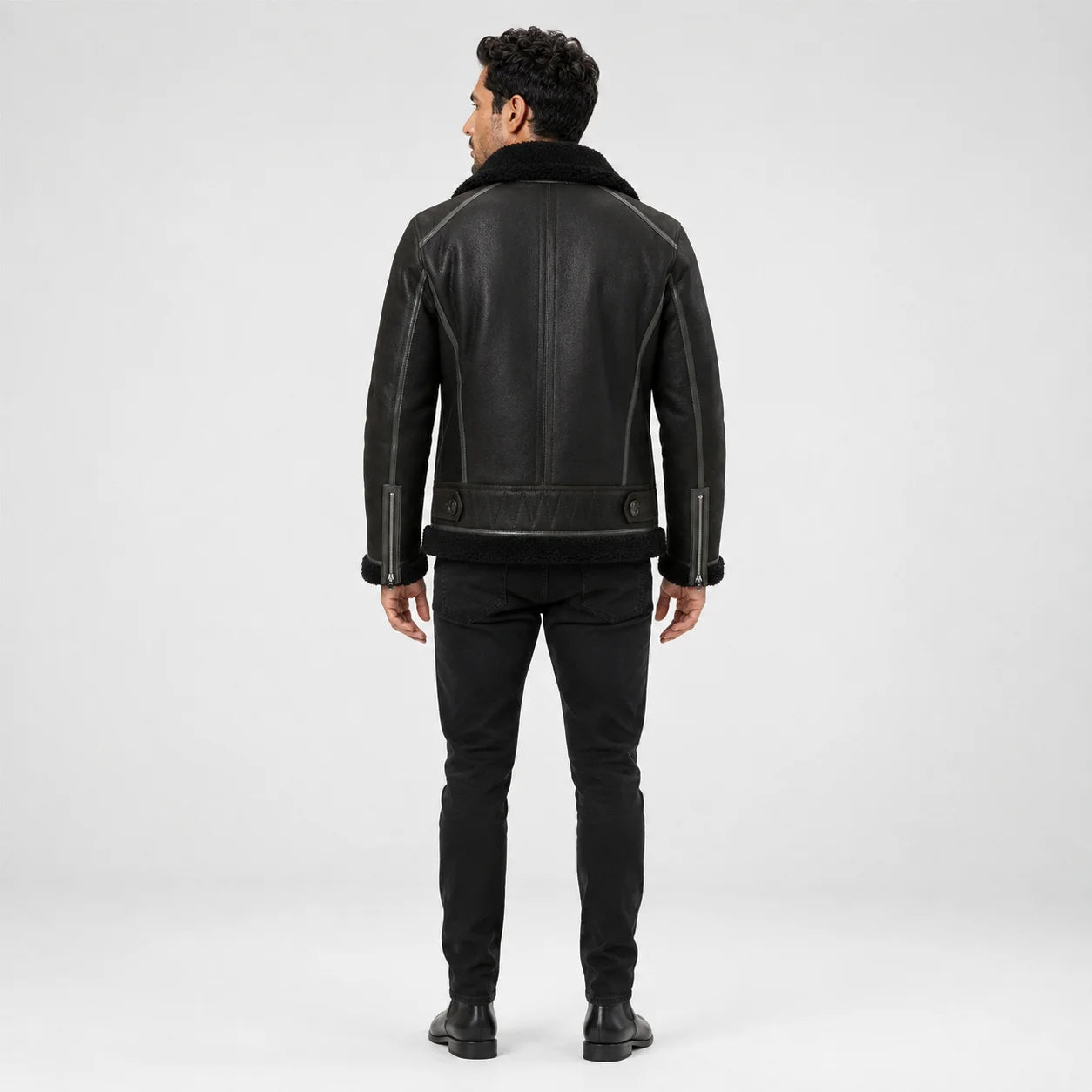 Rear model view showing dark green flight jacket with black collar and hem, panel seams and cuff zip details