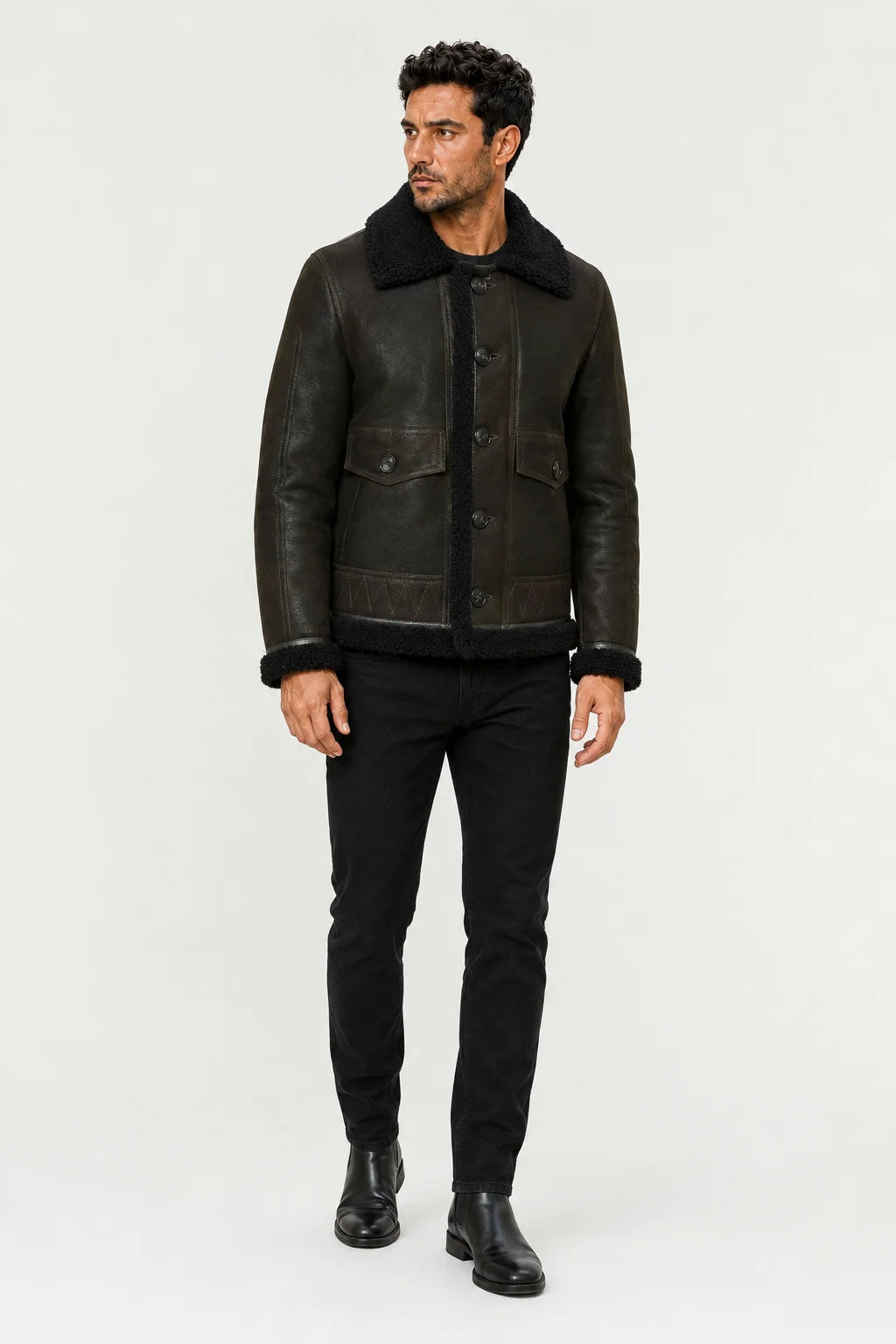 Closer model view of men’s green flight jacket showing plush black trim, button closure and stitched lower panels