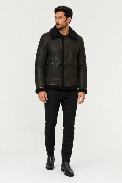 Closer model view of men’s green flight jacket showing plush black trim, button closure and stitched lower panels