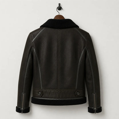 Hanging rear view of dark green flight jacket showing black collar, cuff zips, waist tabs and structured back seams