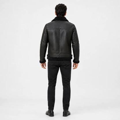 Rear studio view of dark green flight jacket showing black collar and hem trim, structured seams and waist adjusters