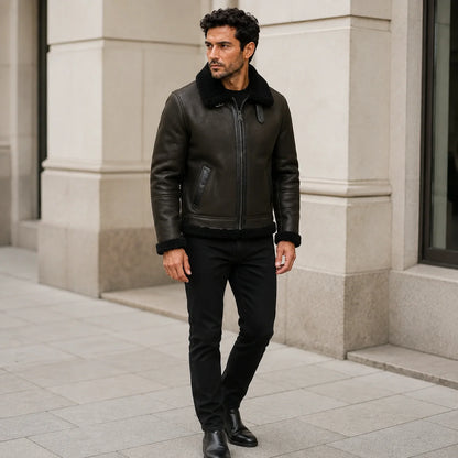 Outdoor lifestyle view of men’s dark green aviator jacket with black collar styled with black jeans and boots