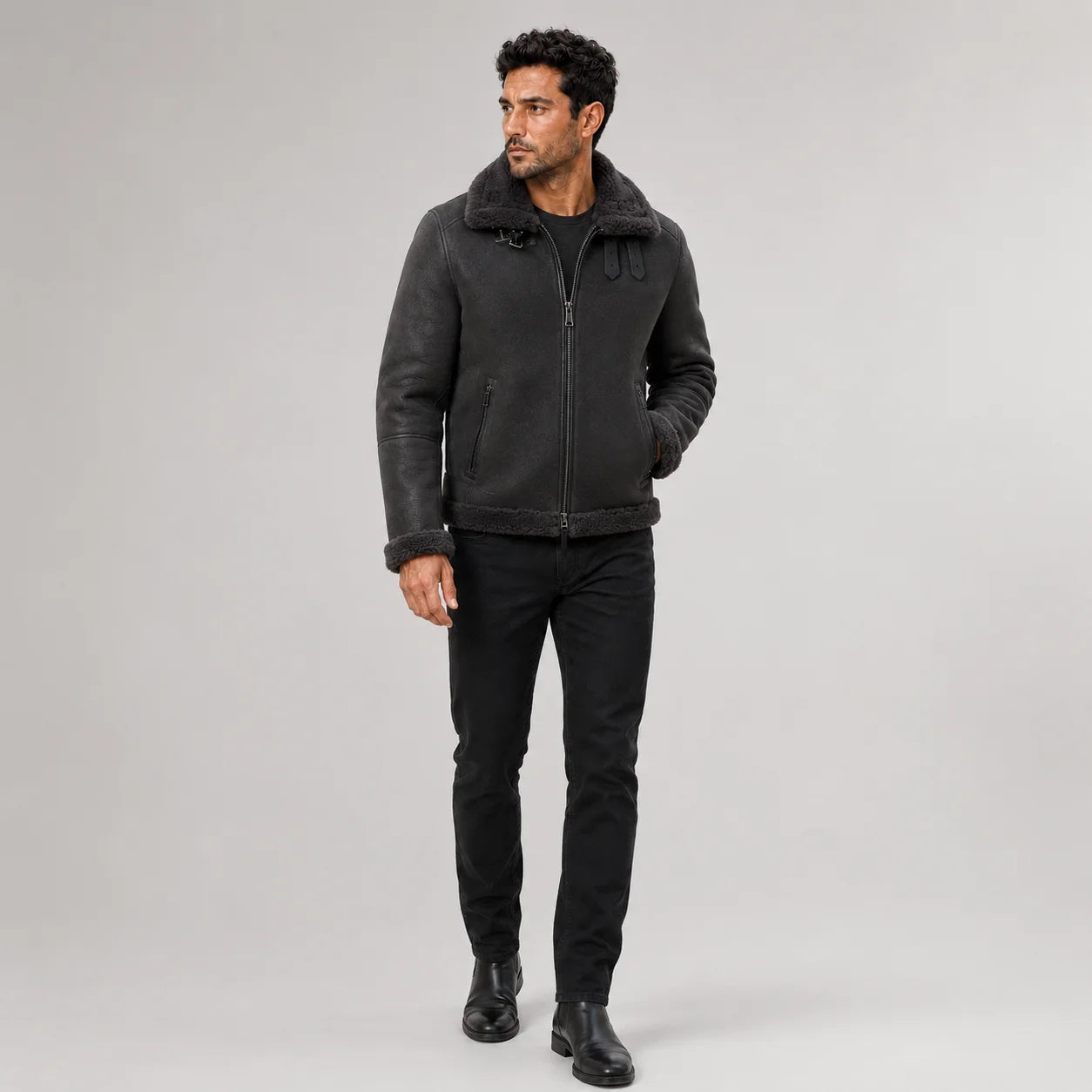 Front studio view of men’s dark grey aviator jacket with tonal plush collar, zip pockets and buckle straps