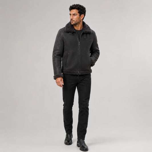 Front studio view of men’s dark grey aviator jacket with tonal plush collar, zip pockets and buckle straps