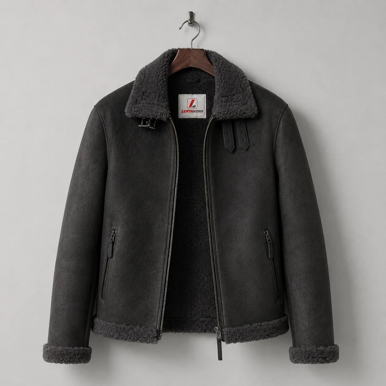 Hanging front view of charcoal aviator jacket with dark plush lining, buckle collar and two zipped hand pockets