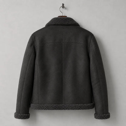 Hanging rear view of dark grey flight jacket with clean shoulder yoke, centre-back seam and plush hem trim