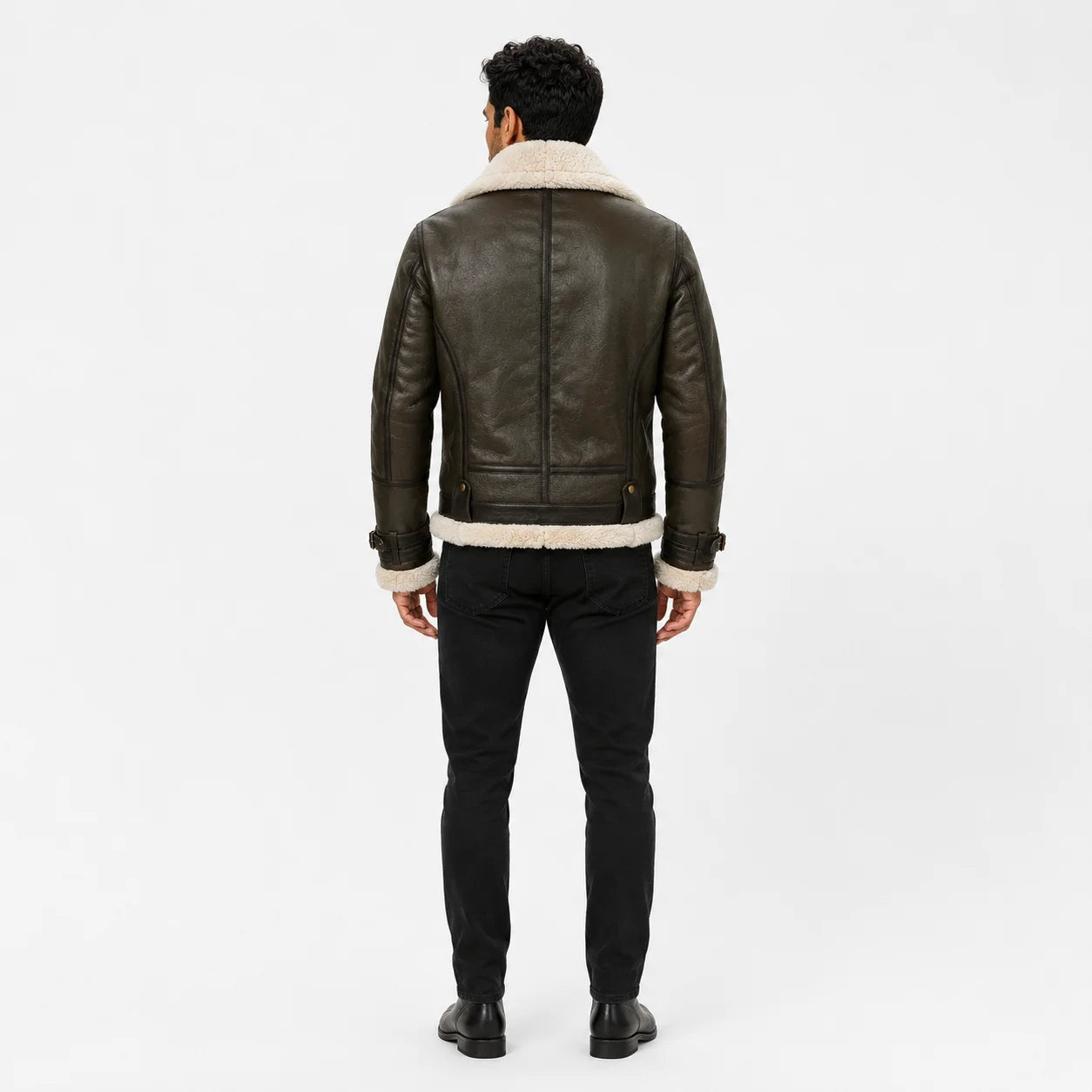 Rear studio view showing dark olive leather back panels, cream shearling collar and hem on men’s aviator jacket