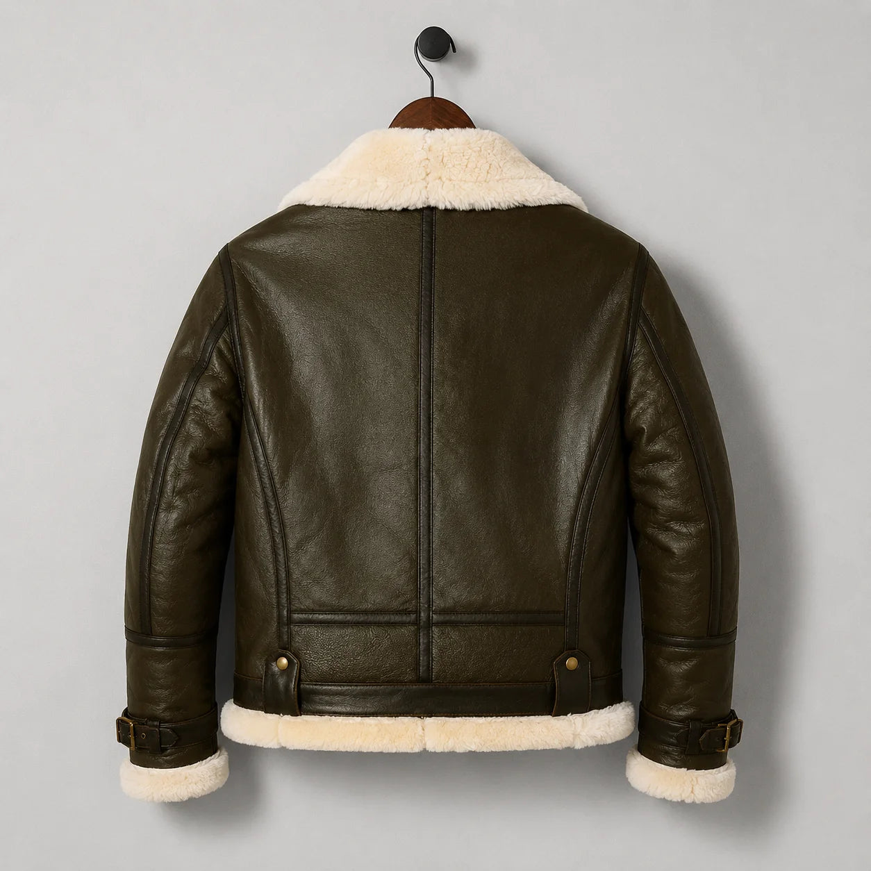 Back hanging view of men’s dark olive shearling jacket with central seam, shaped rear panels and cream collar trim
