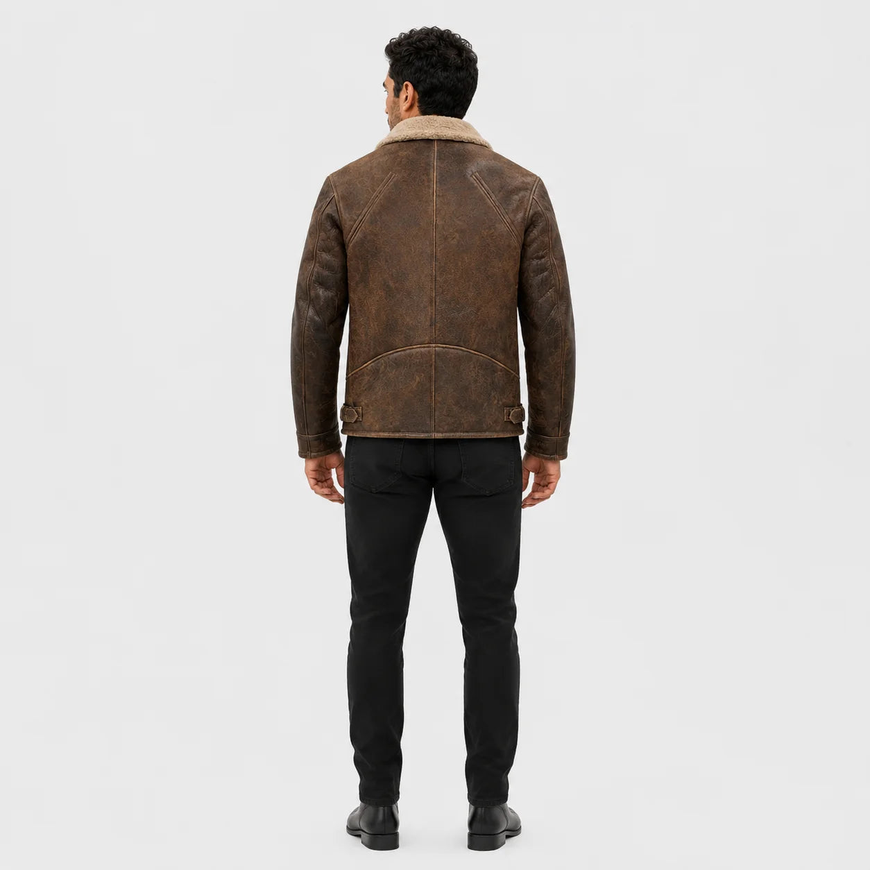 Rear model view of distressed brown biker jacket showing centre back seam, shaped lower panel and side adjustment tabs