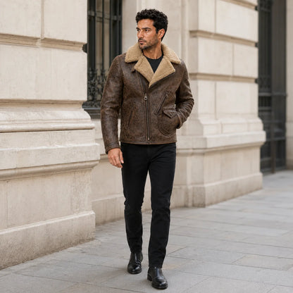 Men wearing distressed brown biker jacket outdoors with black jeans and boots in a premium city setting