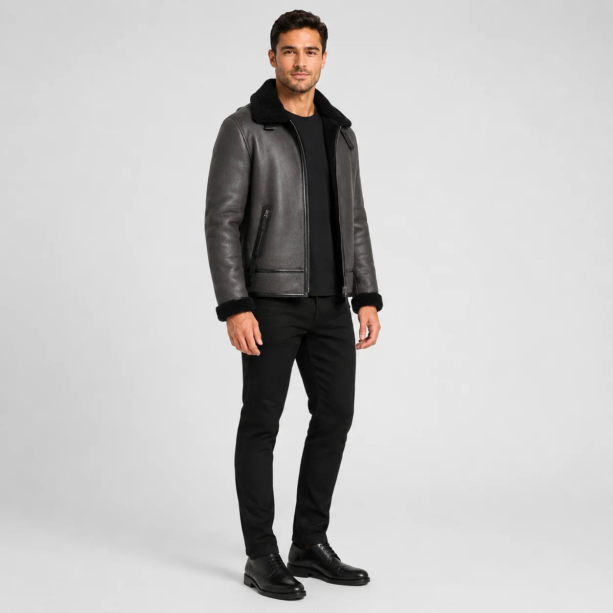 Three-quarter studio view of grey flight jacket with black plush trim, zip pockets and structured short silhouette