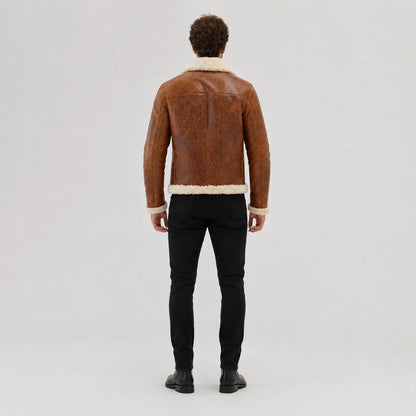 Rear studio view of tan flight jacket showing cream collar and hem trim with clean centre and shoulder seams
