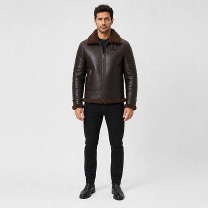 Front model view of tobacco brown aviator jacket with plush brown collar, centre zip, welt pockets and matching cuff trim