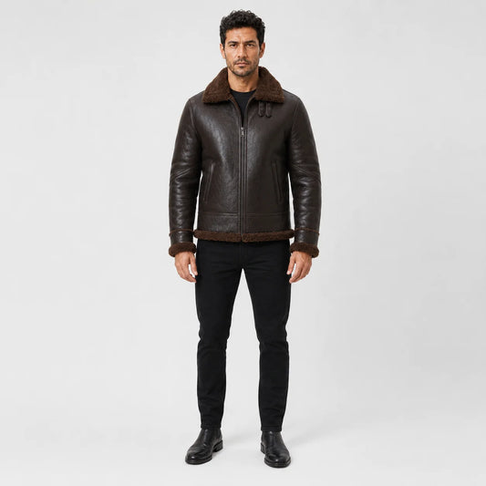 Front model view of tobacco brown aviator jacket with plush brown collar, centre zip, welt pockets and matching cuff trim