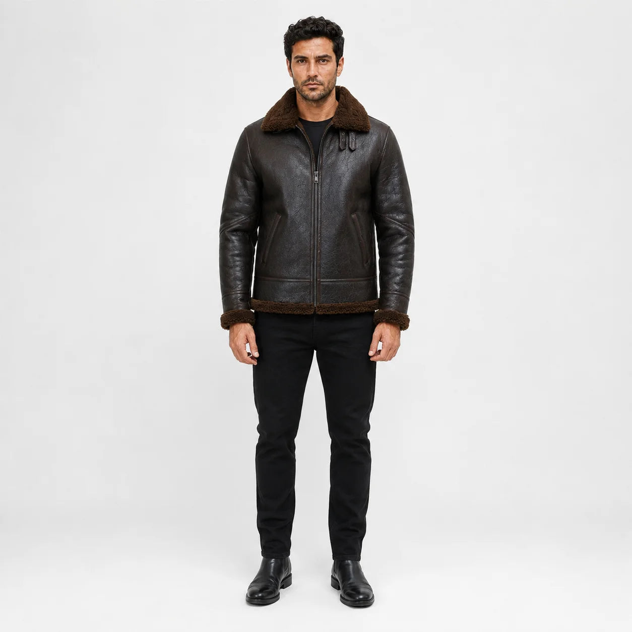 Straight-on studio view showing dark brown flight jacket, plush collar, zip front, side pockets and brown hem trim