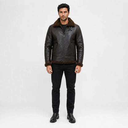 Straight-on studio view showing dark brown flight jacket, plush collar, zip front, side pockets and brown hem trim