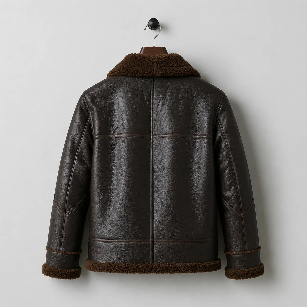 Hanging rear view showing textured brown flight jacket, plush collar and cuffs, centre seam and horizontal back panels