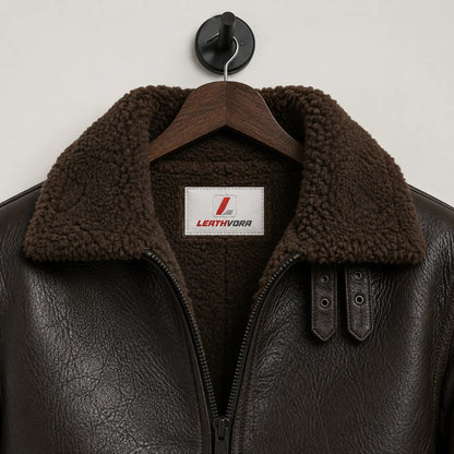 Close-up of brown plush aviator collar and lining with textured dark brown outer, front zip and Leathvora branding