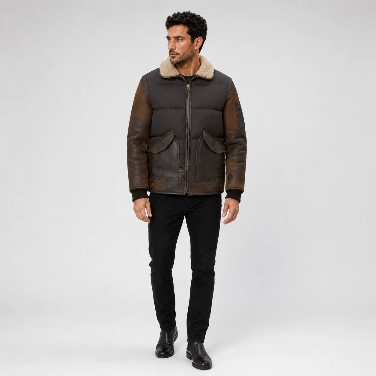 Front model view wearing vintage brown leather puffer jacket with shearling collar and large flap pockets.