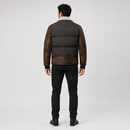 Rear model view showing dark padded back panels, distressed brown leather sleeves and ribbed cuffs.