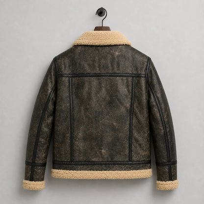 Hanging rear view of dark distressed sheepskin jacket with horizontal shoulder yoke, vertical seams and cream trim